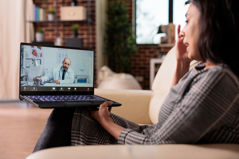 A person using a laptop in a private setting for online sexual health consultation