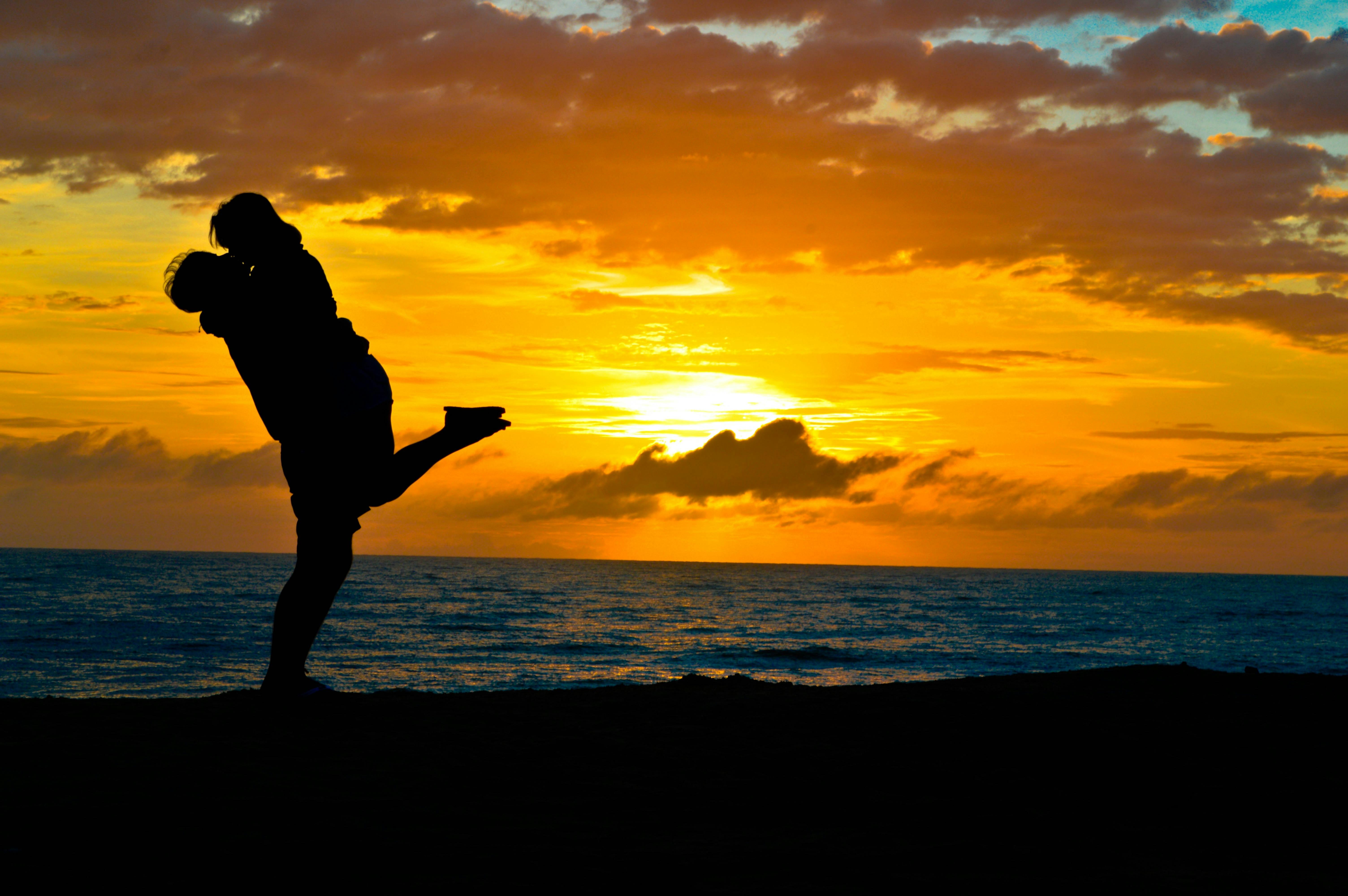 First Time Couples Hugging in sunset