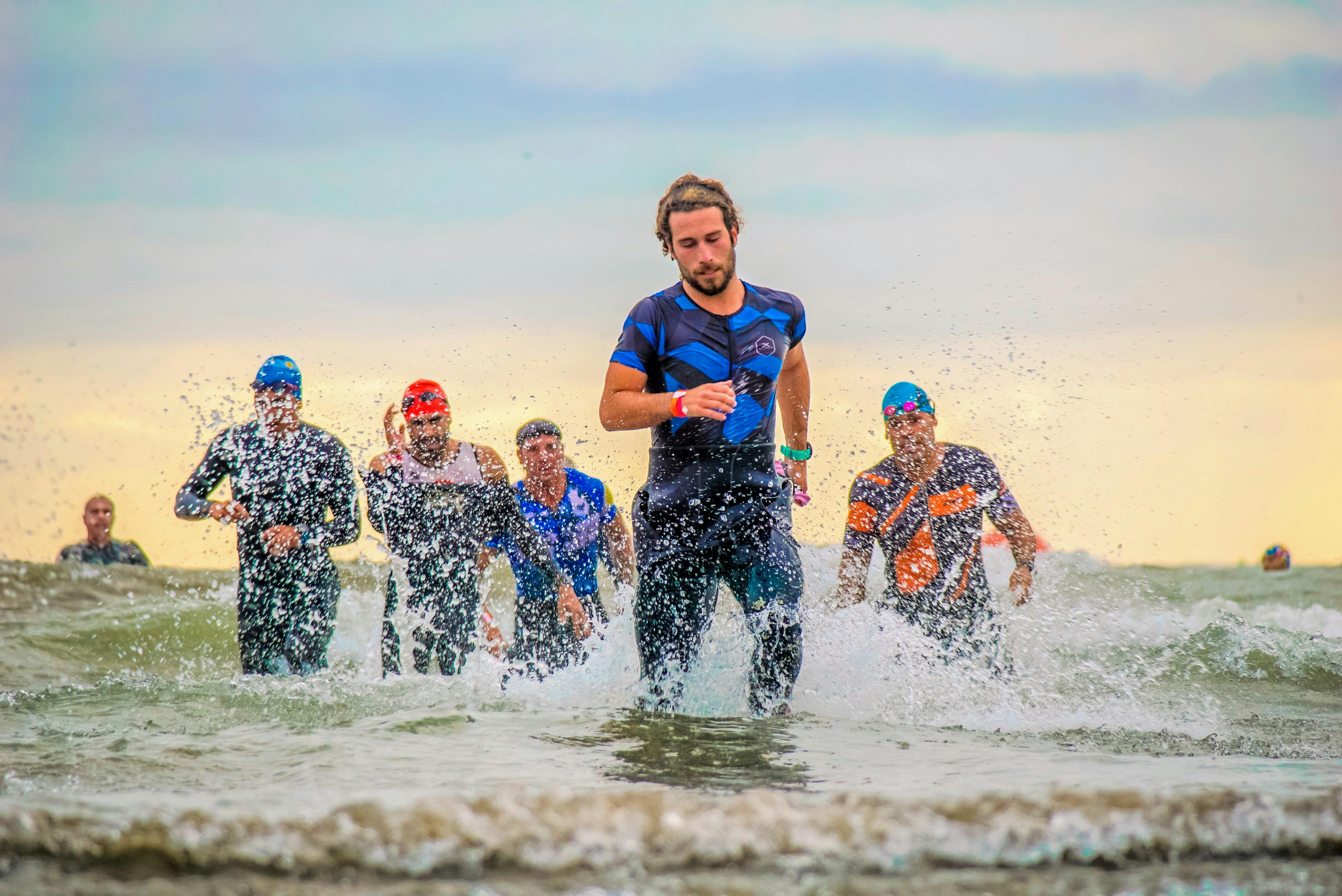 Men running in water triathlon